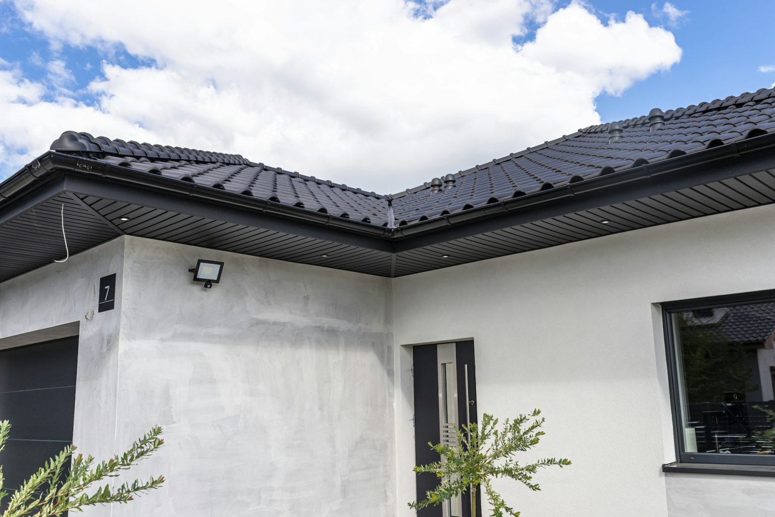 A modern graphite herringbone roof lining is attached to the trusses, visible turned on LED lights.